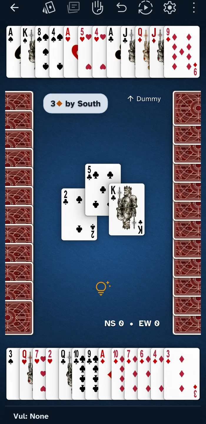 Declaring 3 diamonds as South, mid-trick, with dummy face up along the top and the hint lightbulb below the trick.